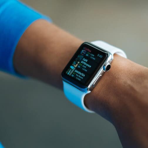 Smartwatch on wrist displaying digital screen